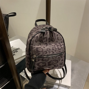 Mini leopard print backpack for women featuring stylish grey-black faux fur and pockets