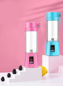 Detailed view of pink and blue portable mini electric blenders with stainless steel blades