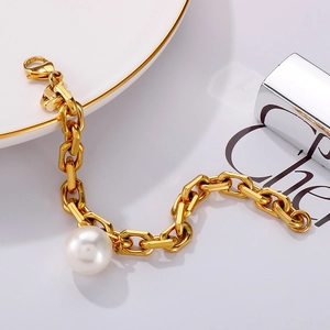 Elegant gold titanium steel bracelet featuring a large white pearl and textured link chain