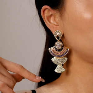 Detailed view of luxury fan-shaped earrings with tiered multi-color zircons and crystals