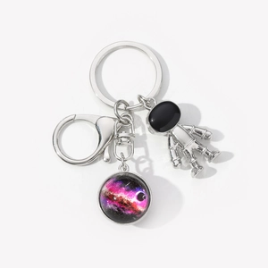 Astronaut keychain with double-sided solar system pendant and silver metal charms