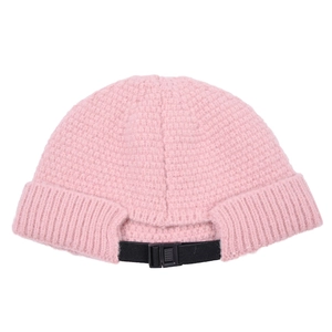 Detail of pink knitted beanie featuring adjustable back strap and ribbed texture