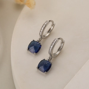 Elegant gold-plated geometric earrings with dark blue zircon pendants in a silver-tone finish