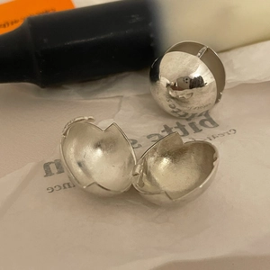 Detail of S925 sterling silver sphere earring with broken eggshell design and hallmark