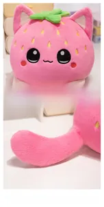 Detail of strawberry cat plush toy featuring embroidered facial expressions and soft tail
