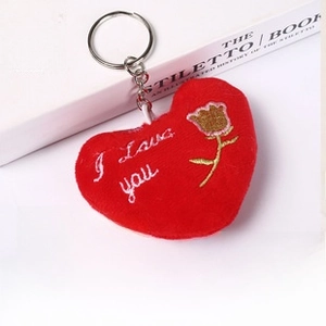Close-up of red heart plush keychain with I Love You embroidery and silver metal ring