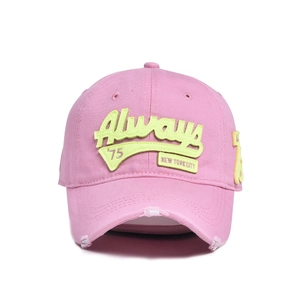 Detail of pink cotton baseball cap featuring neon letter embroidery and distressed brim