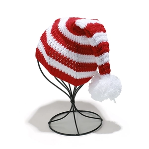 Classic red and white striped knit Christmas hat with white pompom on metal stand