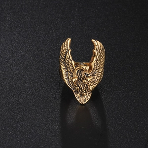 Detailed view of golden eagle ring showing intricate feather textures and retro metal finish