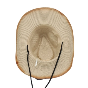 Detail view of woven straw hat interior with adjustable wind rope and sweatband