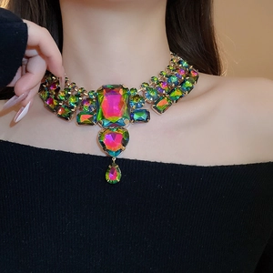 Detailed view of luxury statement necklace with colorful gradient crystals on model