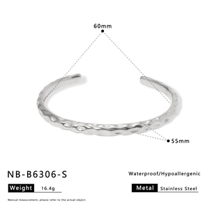 Detail of silver hammered texture on waterproof stainless steel cuff bangle bracelet