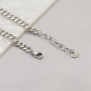 Detail of silver stainless steel Cuban chain bracelet with lobster clasp and extension