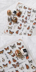 Detail of Maillard butterfly nail stickers with realistic patterns and gold accents