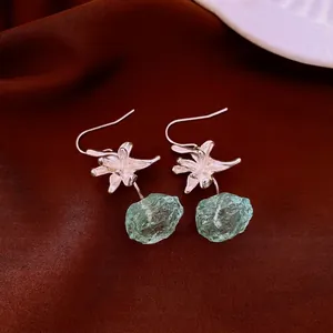 Elegant flower-shaped silver earrings with translucent green resin gemstone pendants