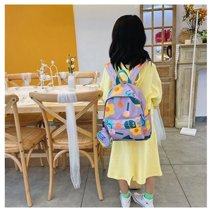 Detail of purple canvas kids backpack with floral print on a child in a cafe setting