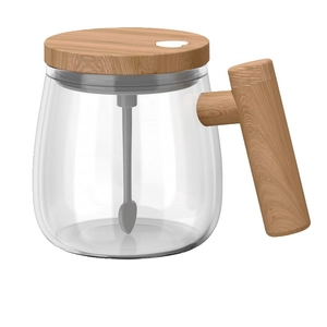 Electric self-stirring glass coffee mug with wooden handle and lid on white background