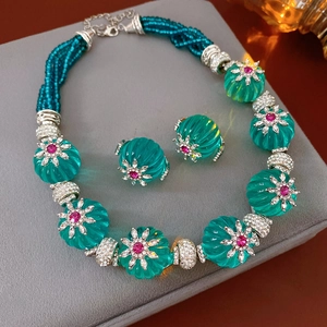 Detail of vintage turquoise bead jewelry set with pink rhinestones and silver metal