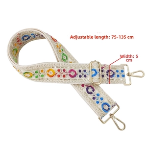 Detail of bohemian embroidery strap with sequins and adjustable golden buckles