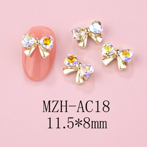 Detail of 3D alloy bowknot nail charms with crystals on pink manicure tips, size 11.5x8mm