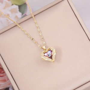 Detail of heart fox pendant with rainbow gem and crystal halo in a beige gift box