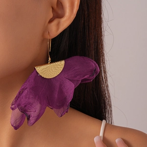 Detail view of purple chiffon flower earrings with textured gold metal ear hooks