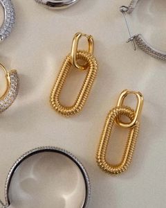 Close-up of 18K gold-plated U-shaped chain link earrings with fine textured spiral pattern