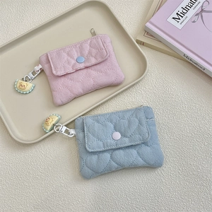 Detail of pink and blue heart quilted coin purses with metal hooks and bear pendants
