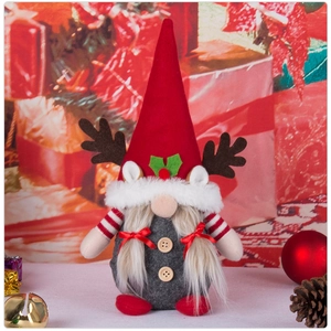 Close-up of Christmas gnome toy with reindeer antlers, fur beard and wooden buttons detail