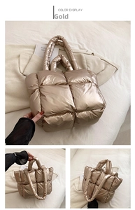 Detail view of gold quilted puffer tote bag with metallic finish and padded handles