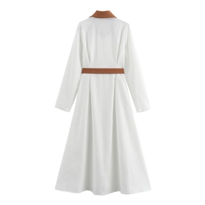 Detail of white corduroy dress featuring a brown suit collar and matching waist belt