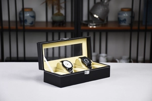 Close-up of black PU leather watch box with glass lid and white stitching detail