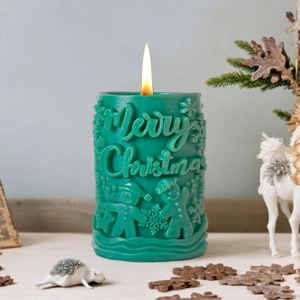 Green cylindrical Christmas candle with gingerbread man relief and Merry Christmas text