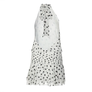 Detailed view of the halter neck bow and black polka dot pattern on the white dress