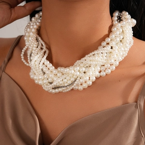 Close-up of elegant multi-layer faux pearl necklace with rhinestone details on a model