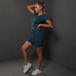 Close-up of seamless dark teal yoga set showing high-waist shorts and cropped top