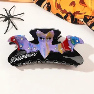 Detail of Halloween bat hair claw clip with purple marble pattern and sparkling rhinestones