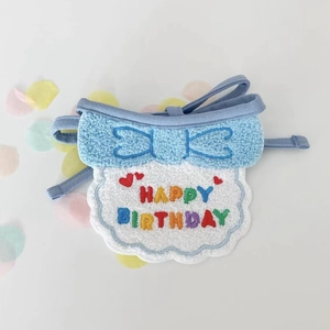 Close-up of sky blue birthday bib with Happy Birthday embroidery and confetti
