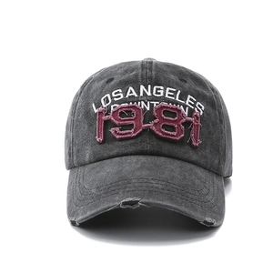 Close-up of vintage washed baseball cap featuring 1981 embroidery and distressed brim detail