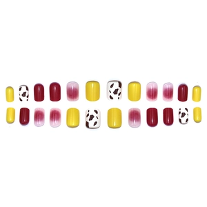 Short square press-on nails set with cherry red, yellow, and cow print designs
