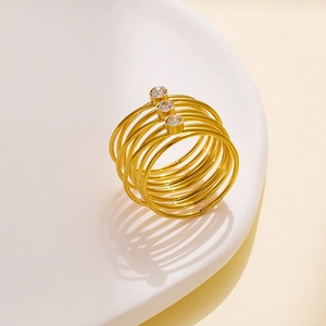 Detail of layered gold-plated titanium ring with three inlaid sparkling crystals