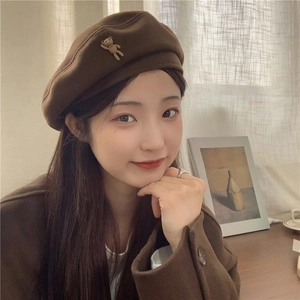 Detail view of a brown wool beret featuring a cute 3D bear accessory for autumn style