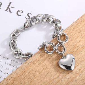 Polished silver heart pendant chunky chain bracelet in stainless steel on wood base