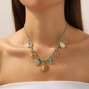 Blue woven necklace with gold celestial, marine charms, shell and pearl accents