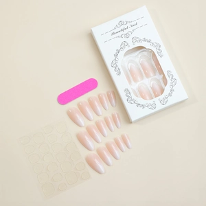 Detail of almond-shaped white gradient press-on nails set with box and tool kit