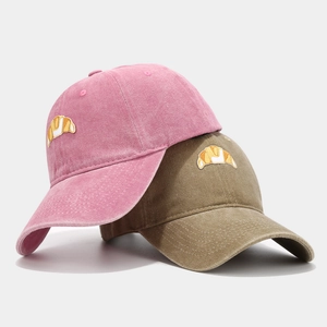 Vintage cotton baseball cap featuring croissant embroidery in pink and khaki colors