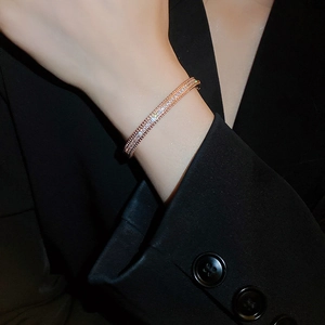 Detailed view of rose gold bracelet featuring three rows of pavé-set shimmering zircons