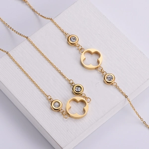 Exquisite gold clover necklace and bracelet set with round cubic zirconia pendants