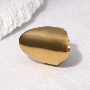 Classic gold hip hop single tooth grillz in 18k plated stainless steel on white texture
