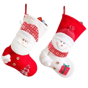 Knitted Christmas stockings featuring Santa and Snowman designs with plush details on white